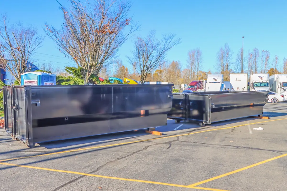 Professional dumpster rental service with roll-off container on residential driveway in Suffield